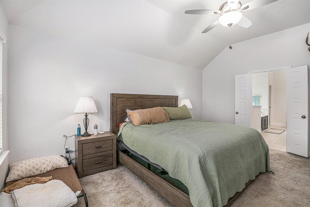 417 Elyse Road Keene, TX 76059 - Photo 10 of 17 a bedroom with a bed and a lamp