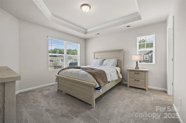 a bed sitting in a bedroom next to a window