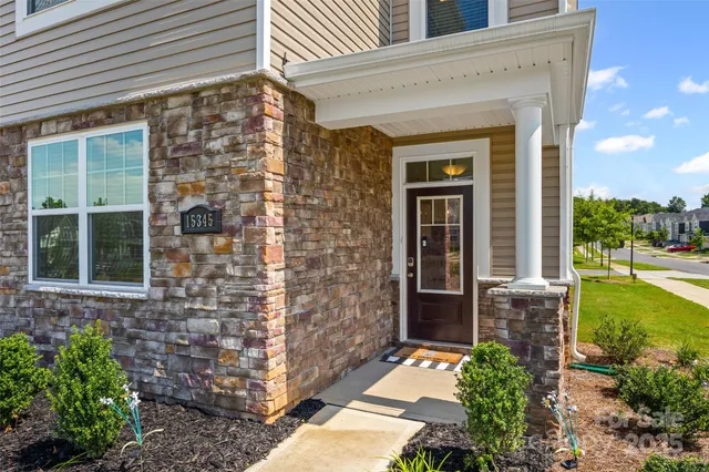 front view of a brick house with a large window