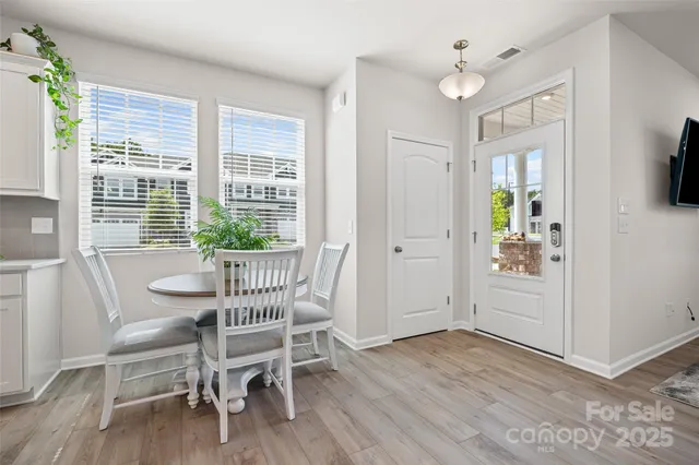 a view of a dining room with furniture window and wooden floor