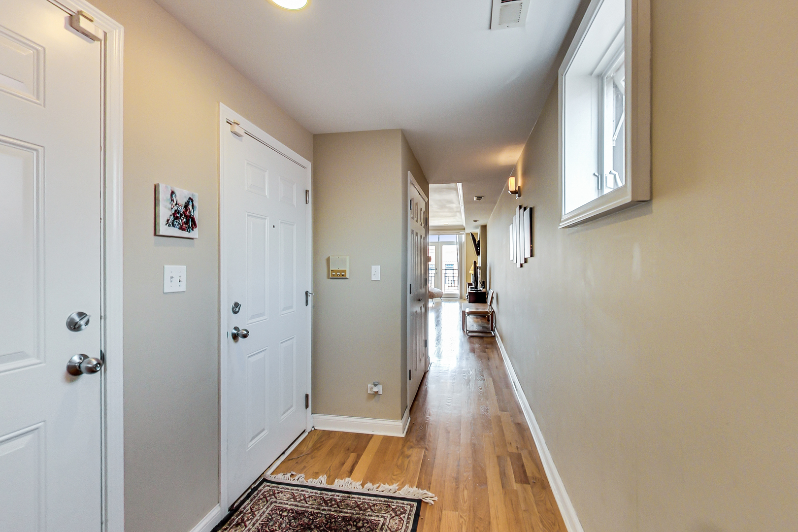 2353 West Harrison Street, Unit 4 Chicago, IL 60612 - Photo 2 of 25 a view of a hallway with wooden floor and a living room