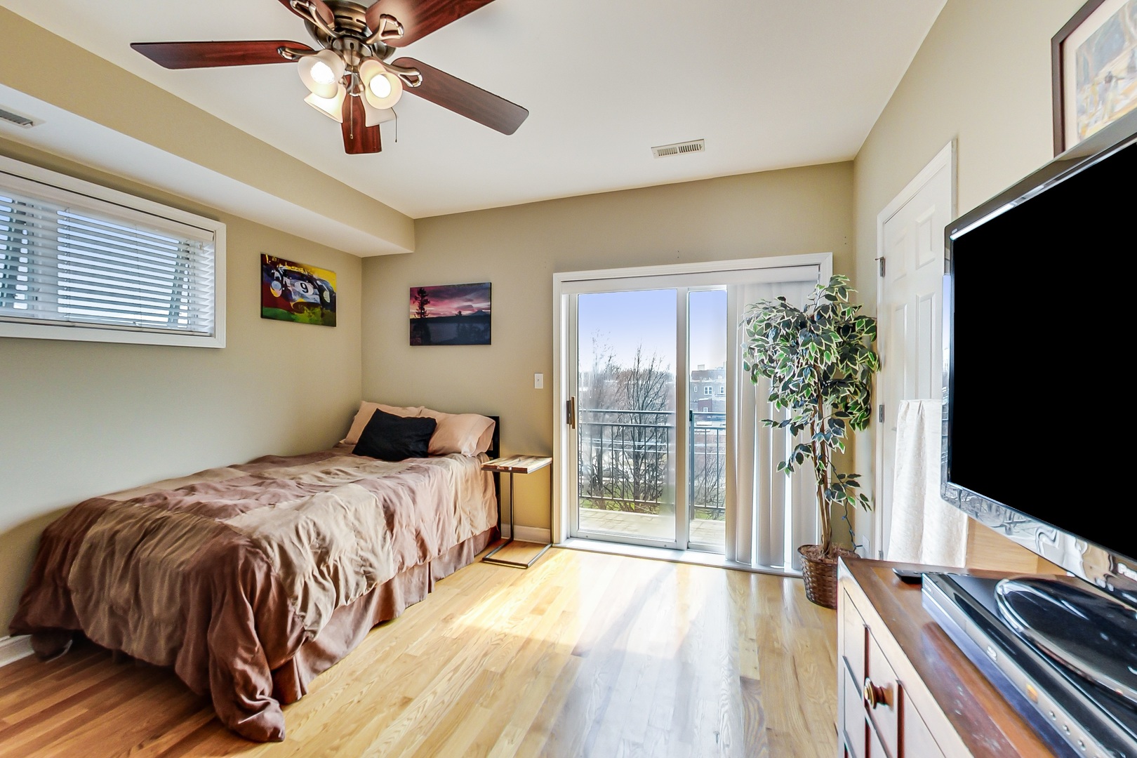2353 West Harrison Street, Unit 4 Chicago, IL 60612 - Photo 11 of 25 a bedroom with a bed and a flat screen tv