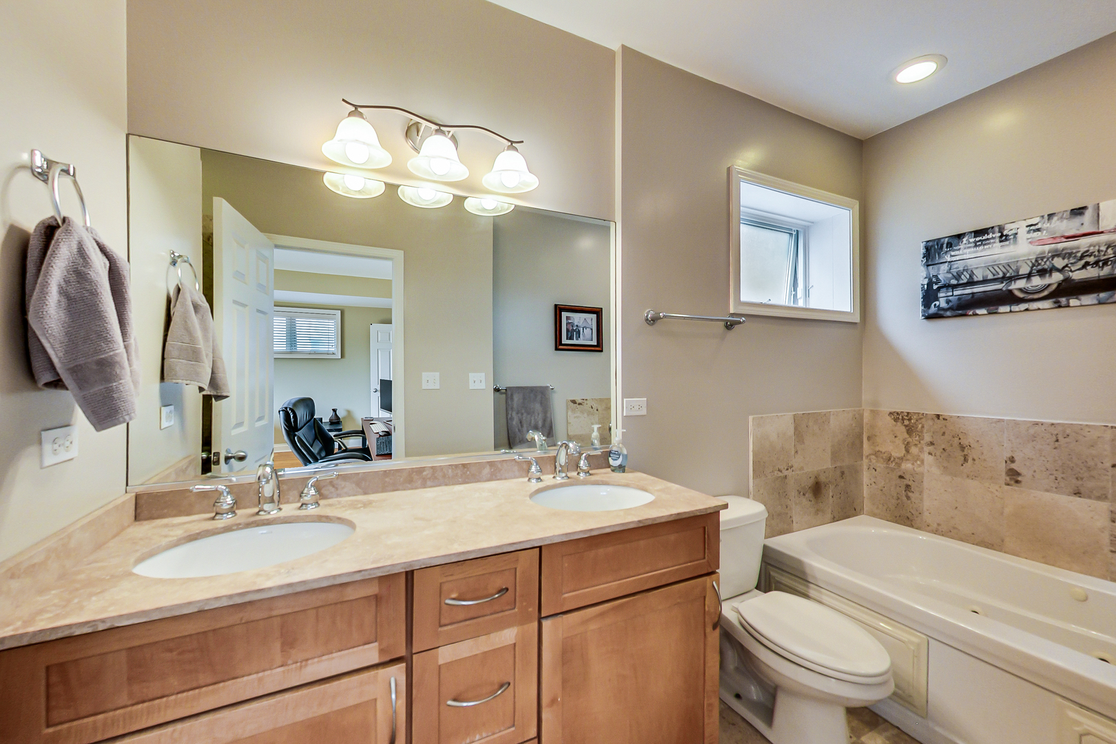 2353 West Harrison Street, Unit 4 Chicago, IL 60612 - Photo 14 of 25 a bathroom with a sink a toilet and a mirror