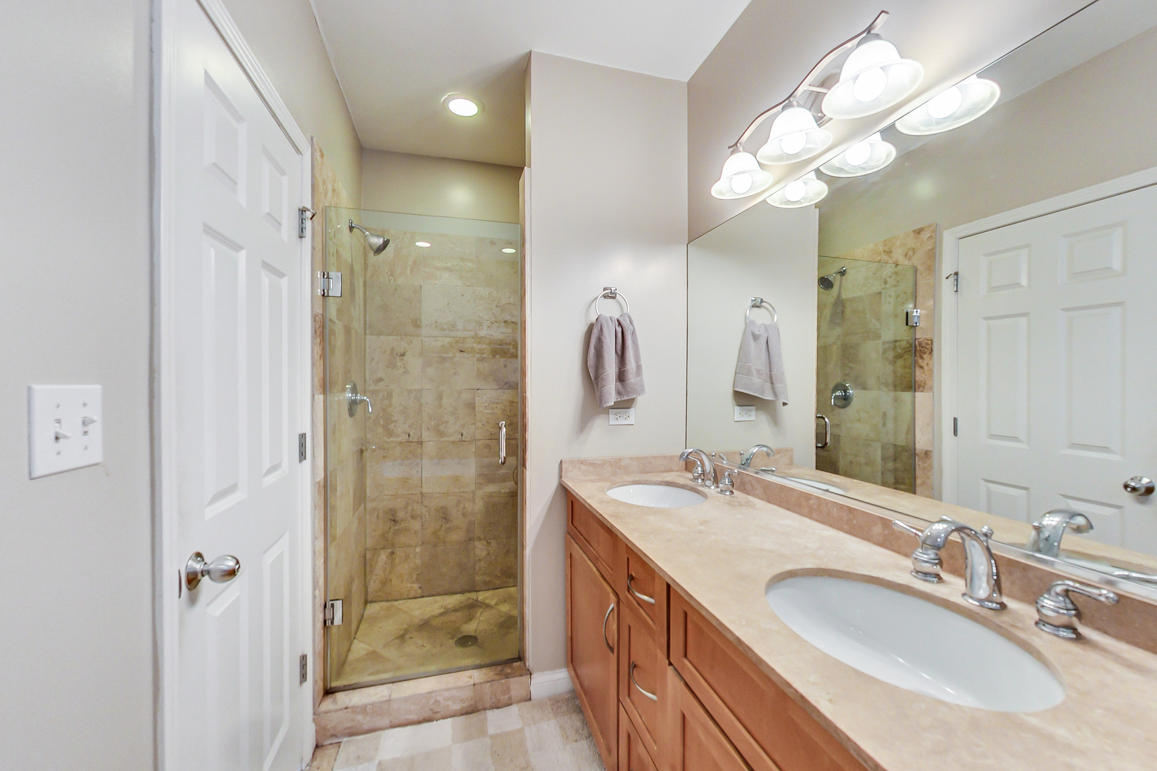 2353 West Harrison Street, Unit 4 Chicago, IL 60612 - Photo 16 of 25 a bathroom with a granite countertop double vanity sink mirror and shower