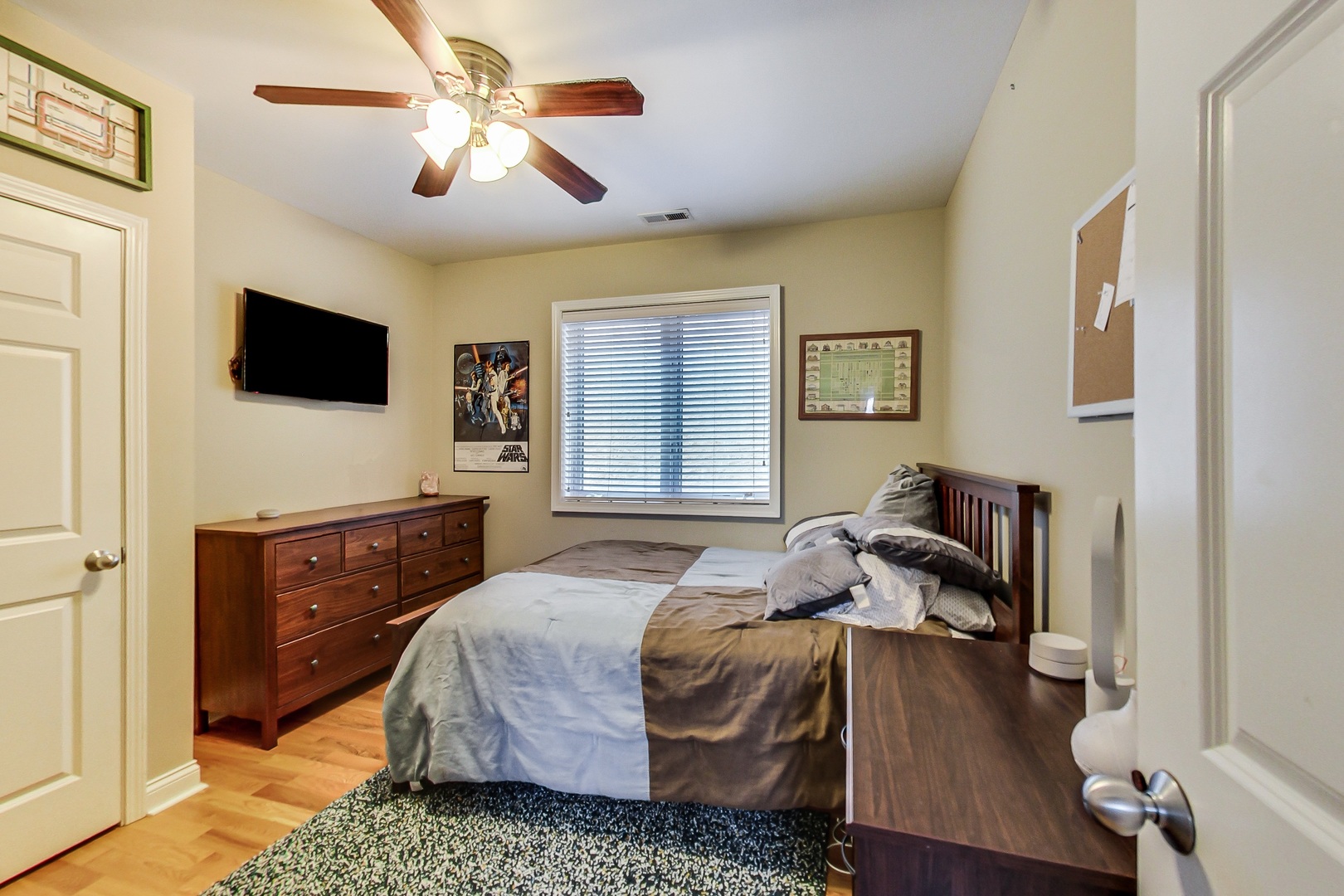 2353 West Harrison Street, Unit 4 Chicago, IL 60612 - Photo 17 of 25 a bedroom with a bed and a flat screen tv