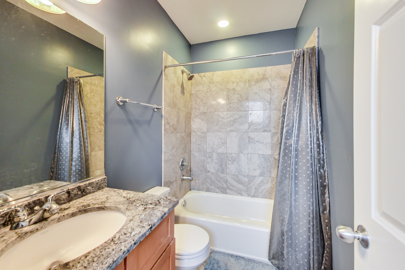 2353 West Harrison Street, Unit 4 Chicago, IL 60612 - Photo 18 of 25 a bathroom with a granite countertop sink toilet and shower