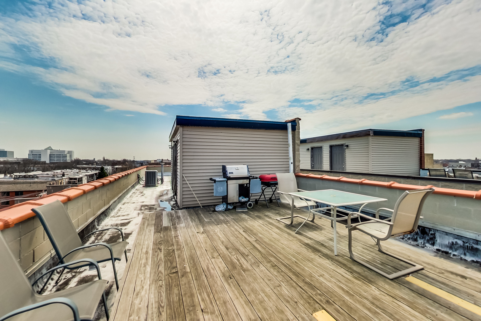 2353 West Harrison Street, Unit 4 Chicago, IL 60612 - Photo 19 of 25 a roof deck with table and chairs