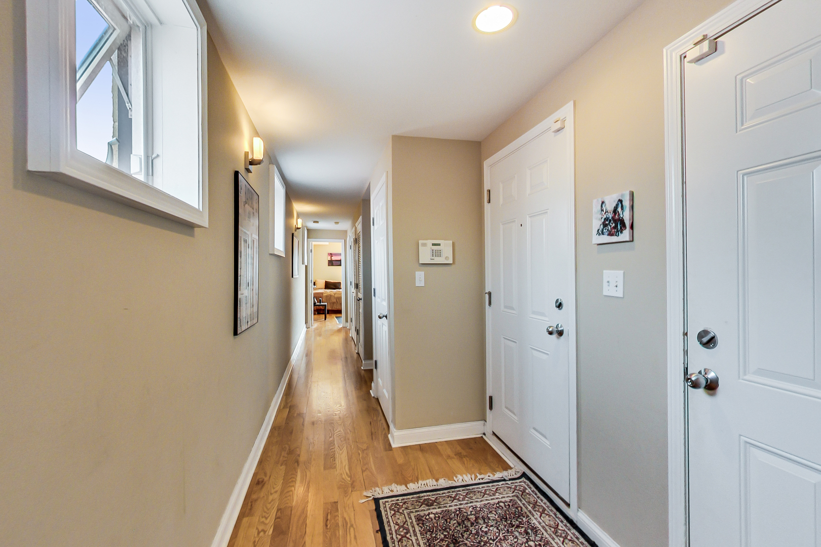 2353 West Harrison Street, Unit 4 Chicago, IL 60612 - Photo 3 of 25 a view of a hallway with wooden floor and staircase