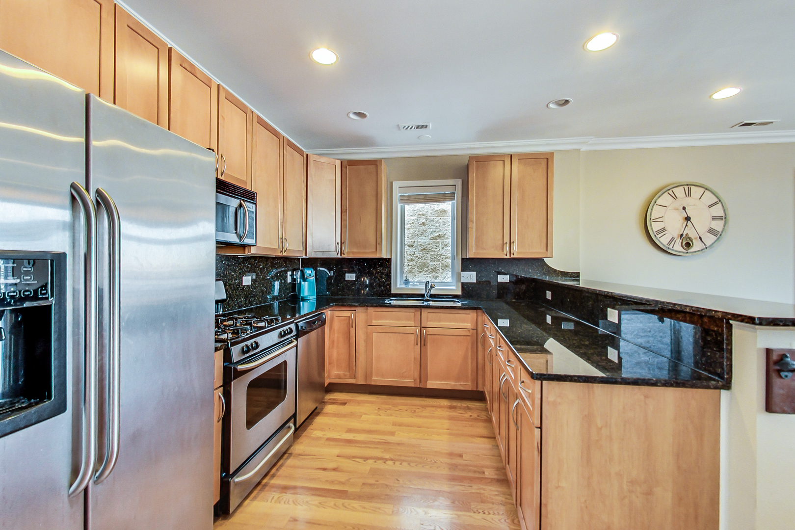 2353 West Harrison Street, Unit 4 Chicago, IL 60612 - Photo 6 of 25 a modern kitchen with stainless steel appliances granite countertop a stove a refrigerator and a sink