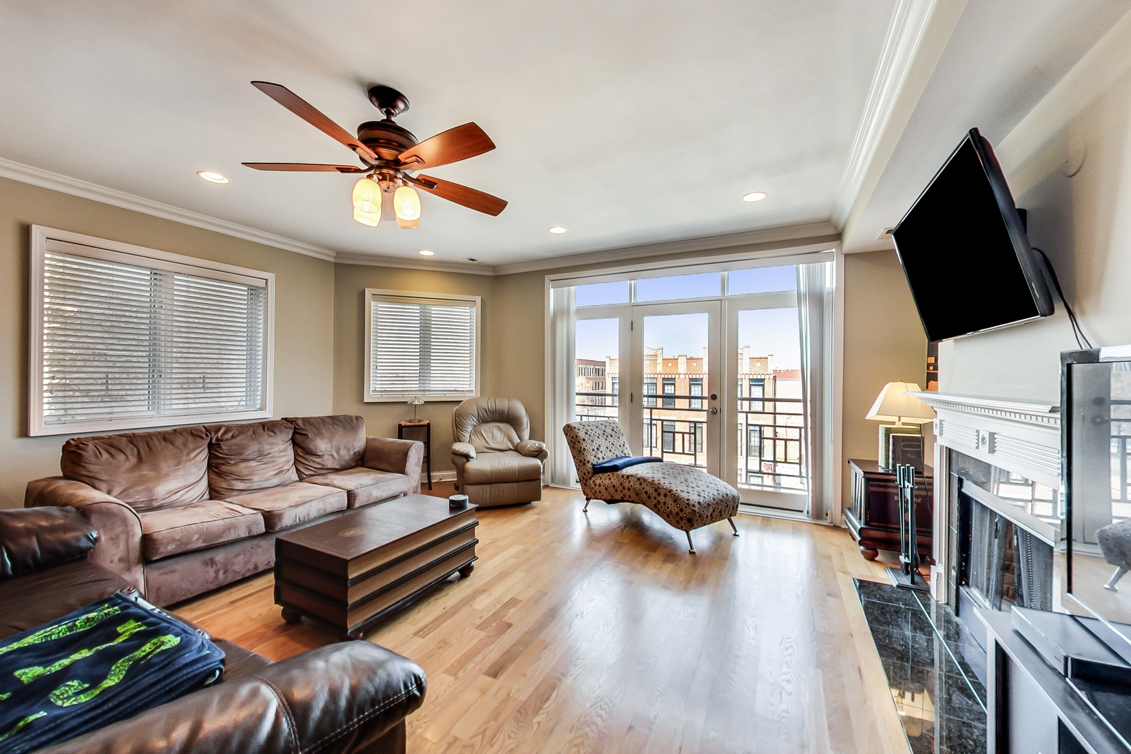 2353 West Harrison Street, Unit 4 Chicago, IL 60612 - Photo 7 of 25 a living room with furniture a fireplace and a flat screen tv