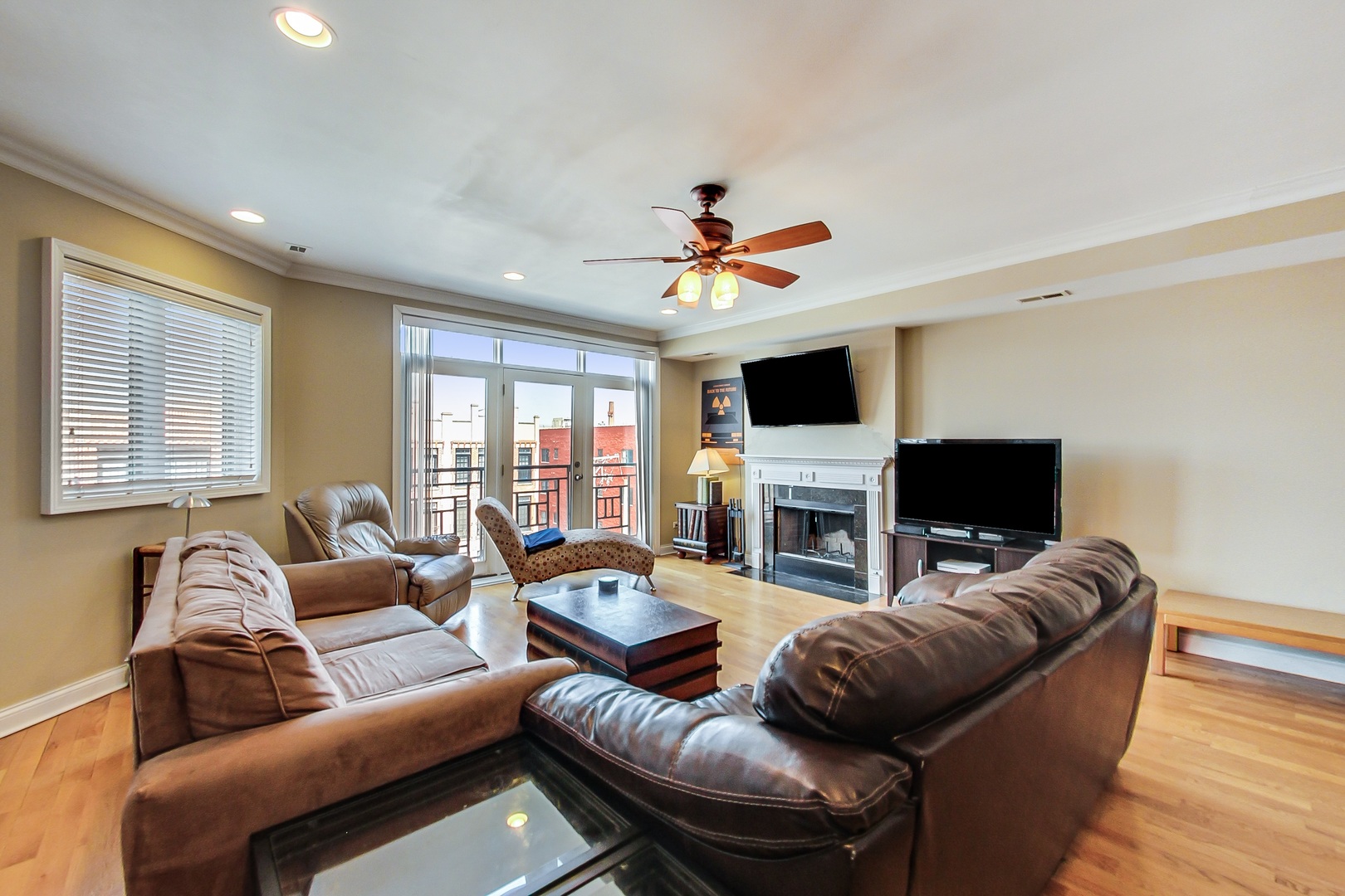 2353 West Harrison Street, Unit 4 Chicago, IL 60612 - Photo 8 of 25 a living room with furniture a fireplace and a flat screen tv