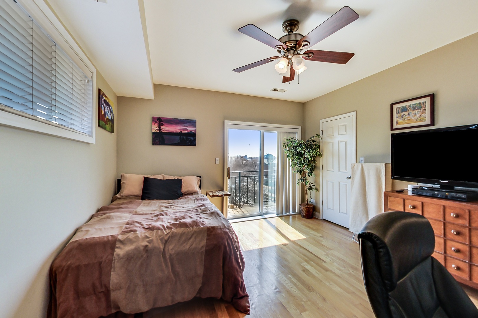 2353 West Harrison Street, Unit 4 Chicago, IL 60612 - Photo 10 of 25 a bedroom with a bed and a flat screen tv