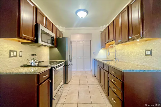 a kitchen with stainless steel appliances granite countertop a sink and a stove