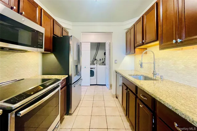 a kitchen with stainless steel appliances granite countertop a stove and a microwave