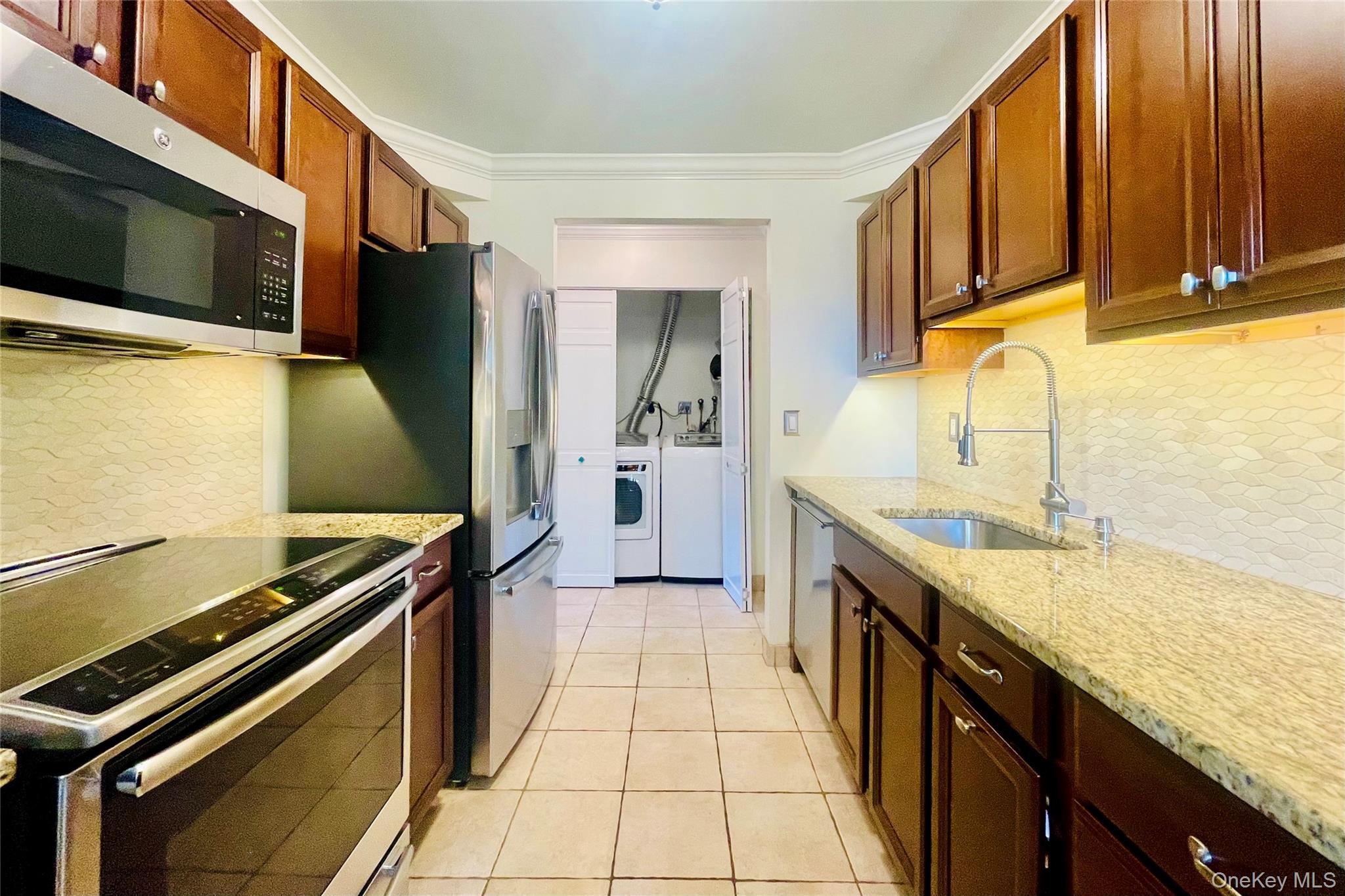 50 Dekalb Avenue, Unit S1 White Plains, NY 10605 - Photo 16 of 28 a kitchen with stainless steel appliances granite countertop a stove and a microwave