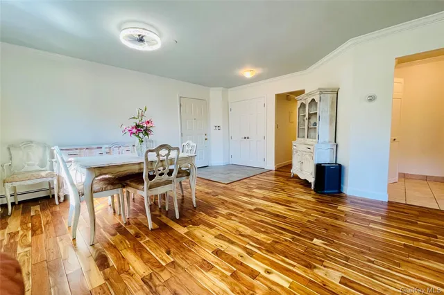 a dining room with furniture and wooden floor