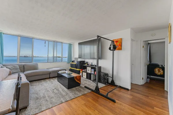a living room with furniture and a wooden floor