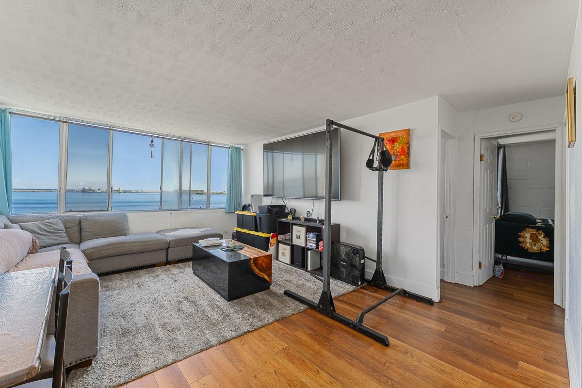 a living room with furniture and a wooden floor