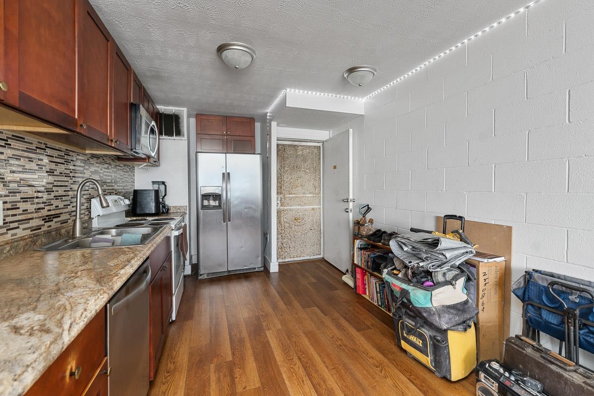 111 Kahului Beach Road, Unit A326 Kahului, HI 96732 - Photo 15 of 43 a kitchen with stainless steel appliances granite countertop a stove and a refrigerator
