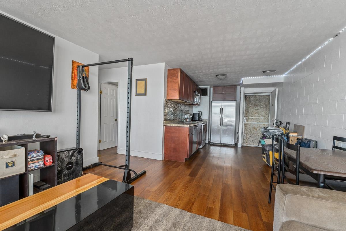 111 Kahului Beach Road, Unit A326 Kahului, HI 96732 - Photo 10 of 43 a room with furniture a flat screen tv and a table