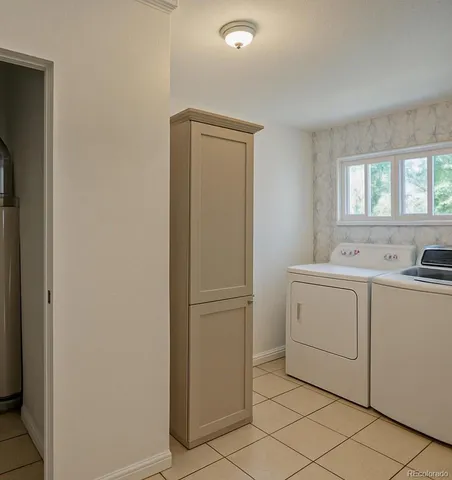 a utility room with cabinets washer and dryer