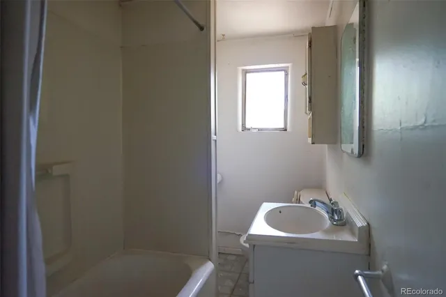 a bathroom with a sink a toilet and mirror