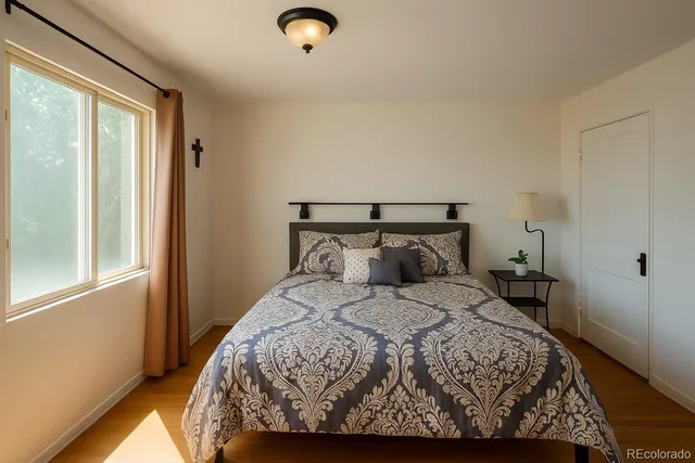 a bed sitting in a bedroom next to a window