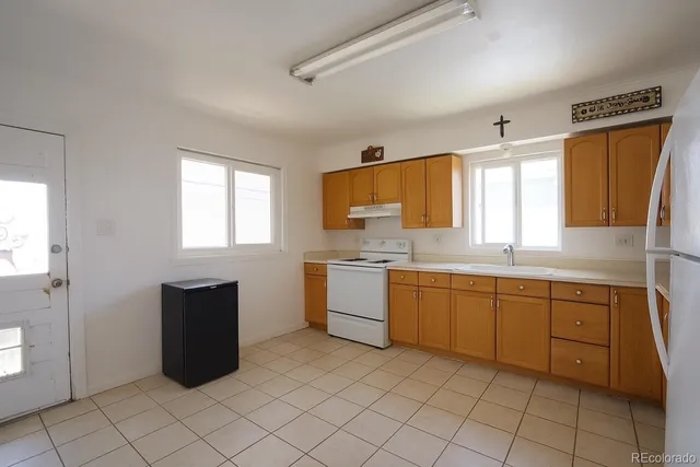 a kitchen with cabinets and window