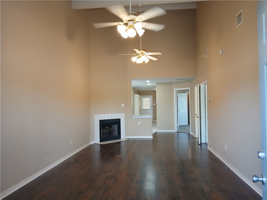 1818 Rodd Field Road Corpus Christi, TX 78412 - Photo 3 of 7 a view of a livingroom with a fireplace a chandelier fan and wooden floor