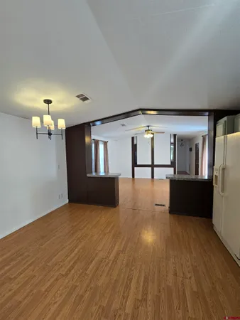 a view of a living room and kitchen with a dishwasher cabinets
