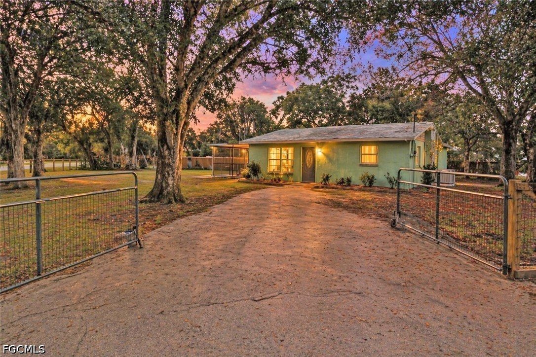 a view of a house with a backyard