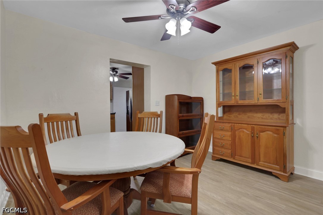 2431 Lippincott Road Alva, FL 33920 - Photo 11 of 43 a view of a dining room with furniture and wooden floor