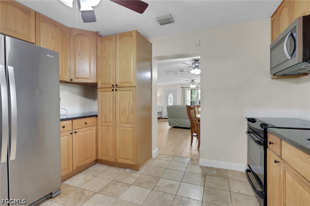 2431 Lippincott Road Alva, FL 33920 - Photo 15 of 43 a kitchen with stainless steel appliances granite countertop a refrigerator and a stove top oven