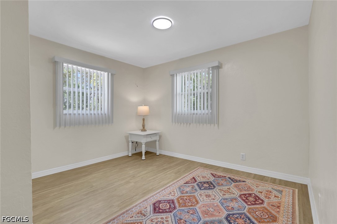 2431 Lippincott Road Alva, FL 33920 - Photo 17 of 43 a view of a livingroom with wooden floor chair and a window