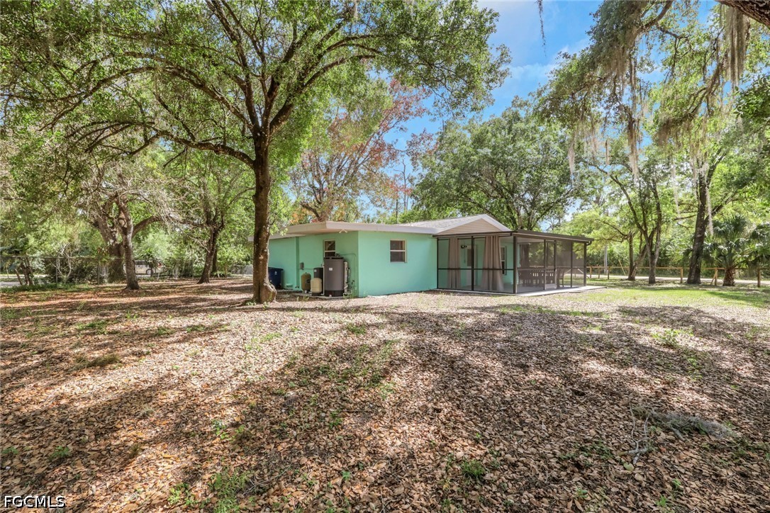 2431 Lippincott Road Alva, FL 33920 - Photo 35 of 43 a view of a house with a yard and tree