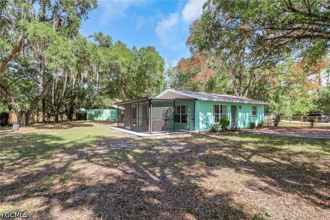 2431 Lippincott Road Alva, FL 33920 - Photo 4 of 43 a front view of a house with a yard