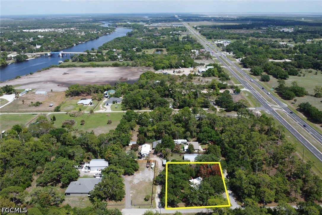 2431 Lippincott Road Alva, FL 33920 - Photo 43 of 43 an aerial view of residential houses with outdoor space and trees
