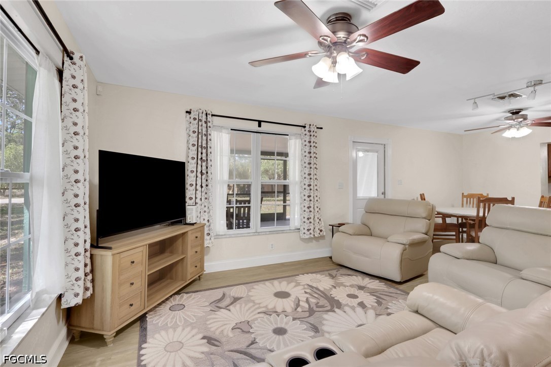 2431 Lippincott Road Alva, FL 33920 - Photo 8 of 43 a living room with furniture and a flat screen tv