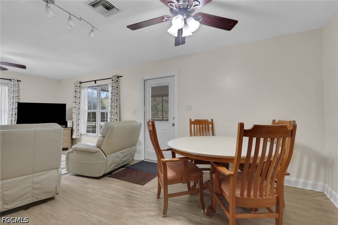 2431 Lippincott Road Alva, FL 33920 - Photo 10 of 43 a living room with furniture dining table and a fireplace