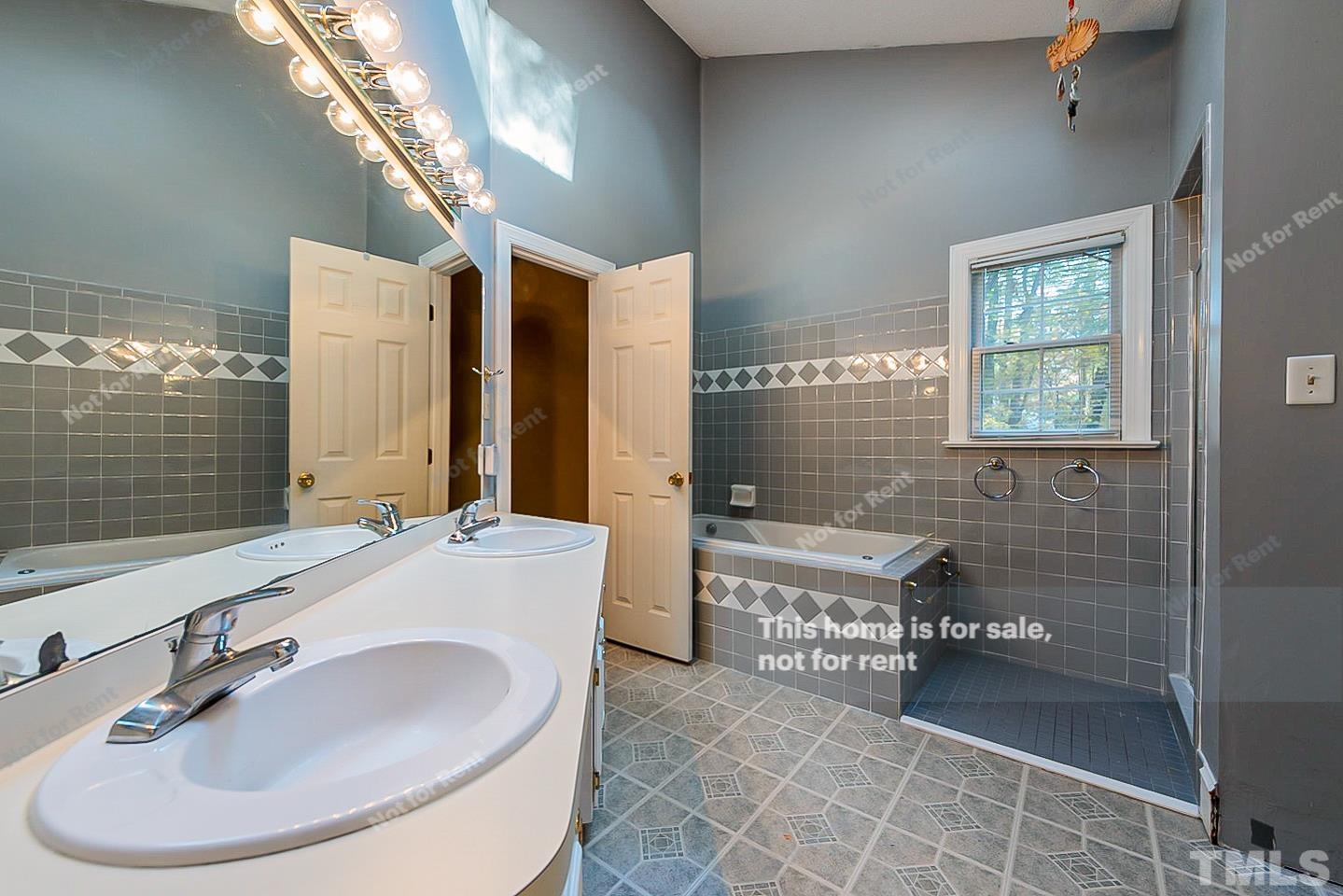 8335 Morgans Way Raleigh, NC 27613 - Photo 19 of 23 a bathroom with a sink and a mirror