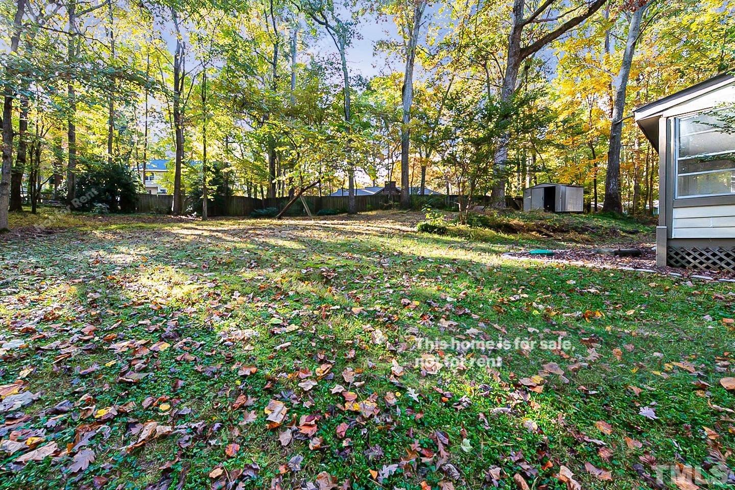 8335 Morgans Way Raleigh, NC 27613 - Photo 21 of 23 a view of yard with swimming pool and trees