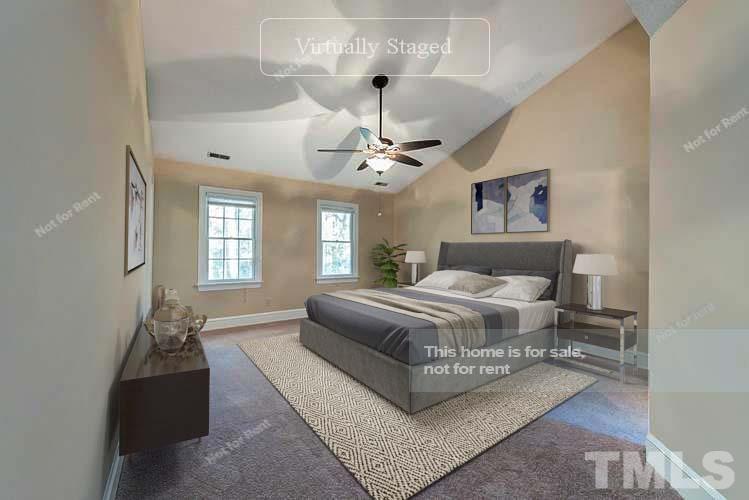 8335 Morgans Way Raleigh, NC 27613 - Photo 7 of 23 a spacious bedroom with a bed a chandelier and a window