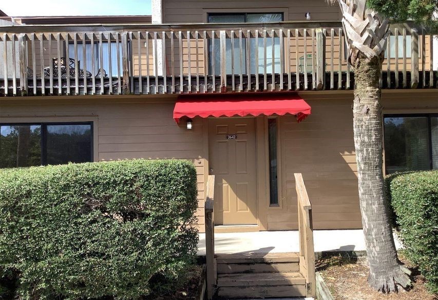 2642 Forest Ridge Drive, Unit E2 Fernandina Beach, FL 32034 - Photo 1 of 1 a front view of a house with a garden