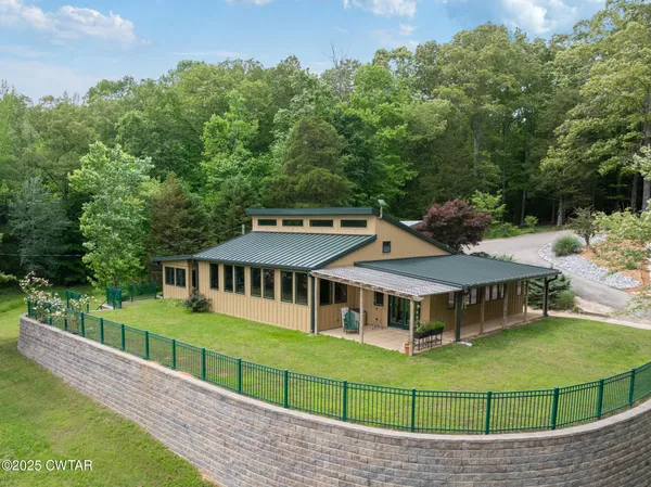 a view of a house with a backyard and a deck
