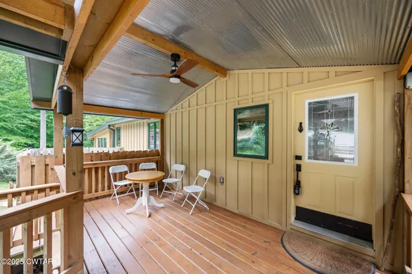 a view of a wooden deck with a yard