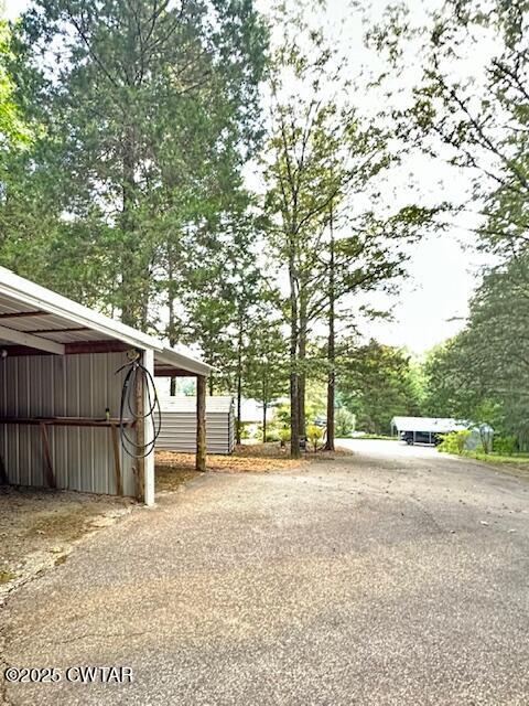 973 Old Lavinia Road Cedar Grove, TN 38321 - Photo 23 of 51 a view of a backyard with large trees and wooden fence
