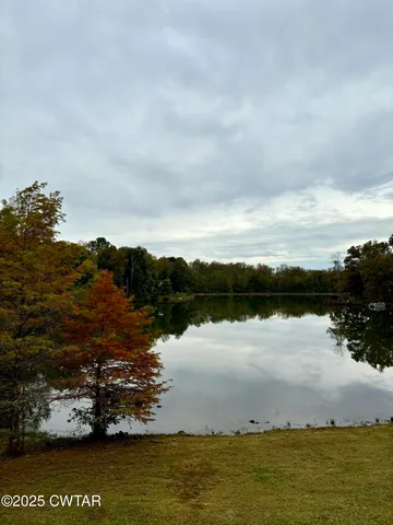 a view of a porch with wooden floor in front of a house