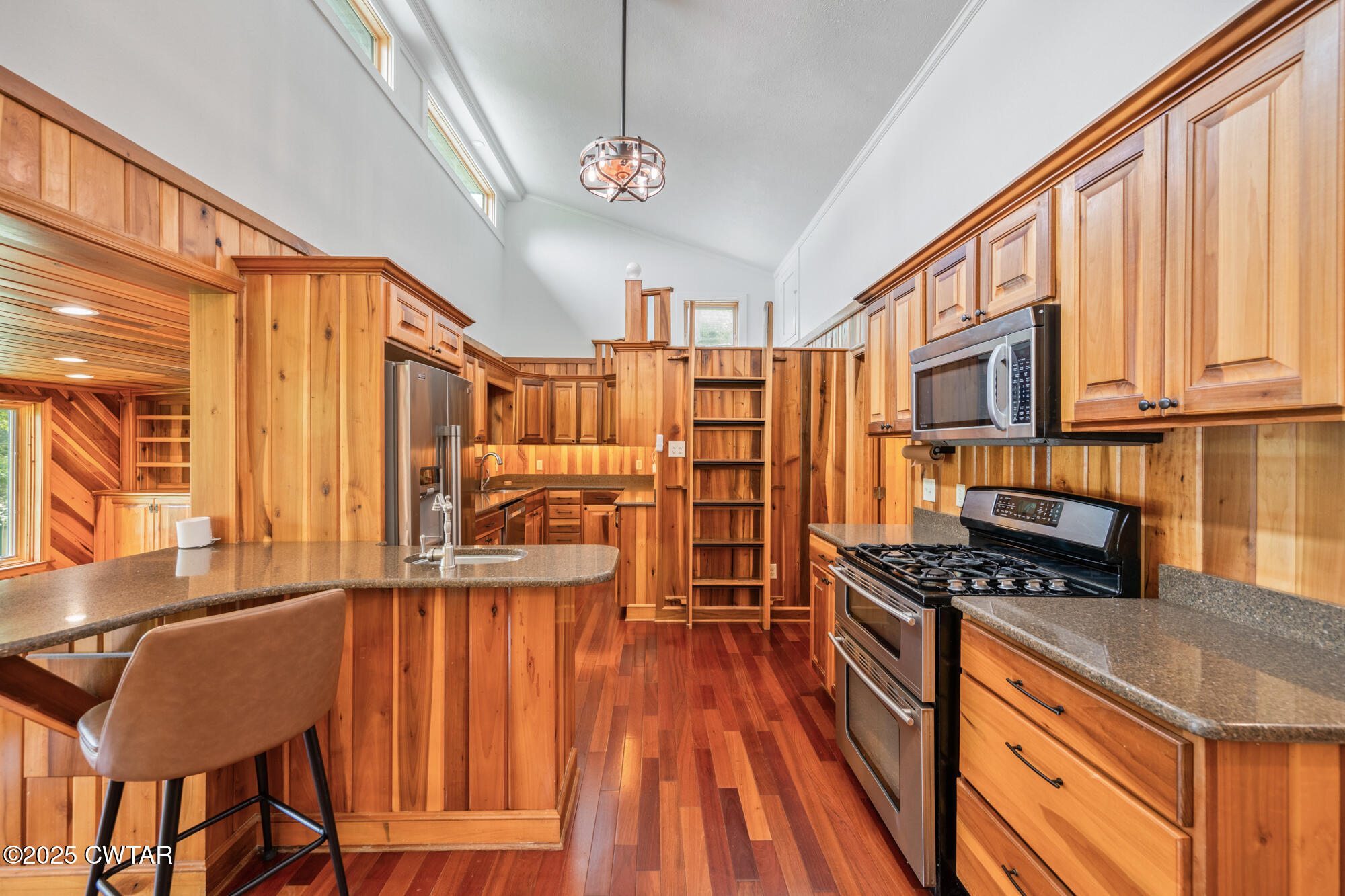973 Old Lavinia Road Cedar Grove, TN 38321 - Photo 35 of 51 a kitchen with stainless steel appliances granite countertop a stove and a wooden cabinets