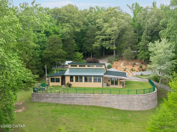a view of backyard with table and chairs and a barbeque