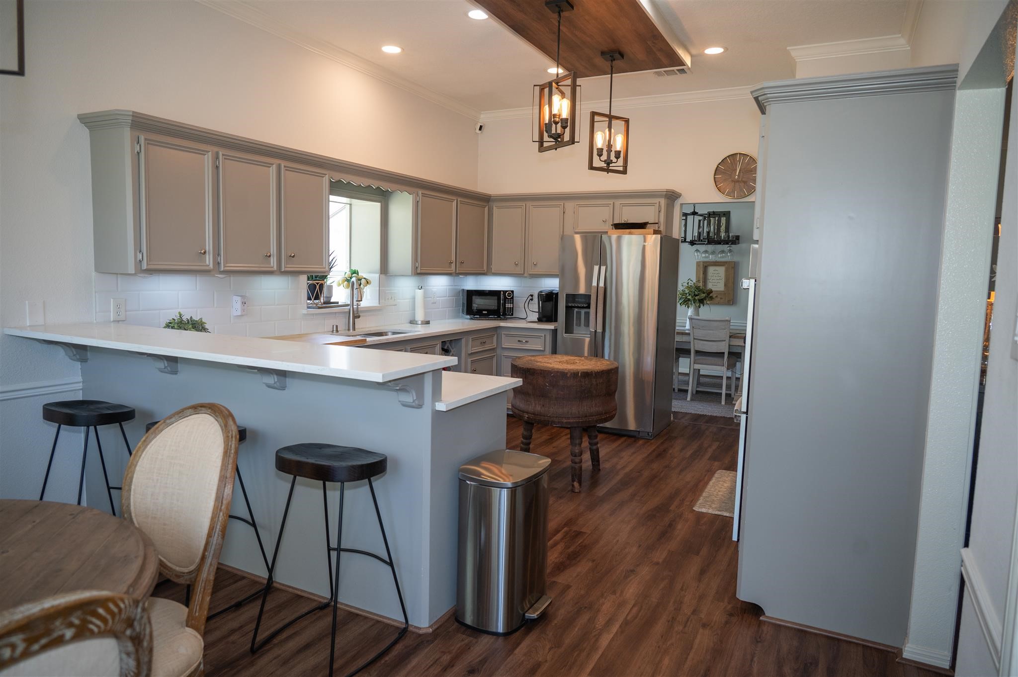 77 Panorama Drive Conroe, TX 77304 - Photo 20 of 49 a kitchen with stainless steel appliances granite countertop a refrigerator a sink dishwasher a stove a dining table and chairs with wooden floor